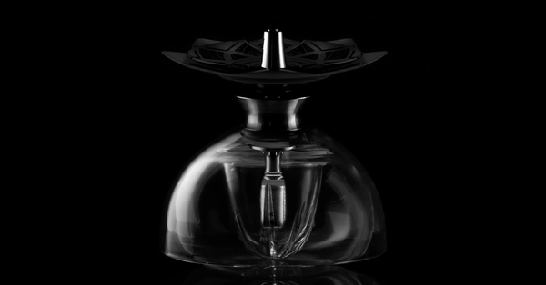 Kaloud Krysalis hookah with a clear glass dome and a Lotus heat management device on top, on black