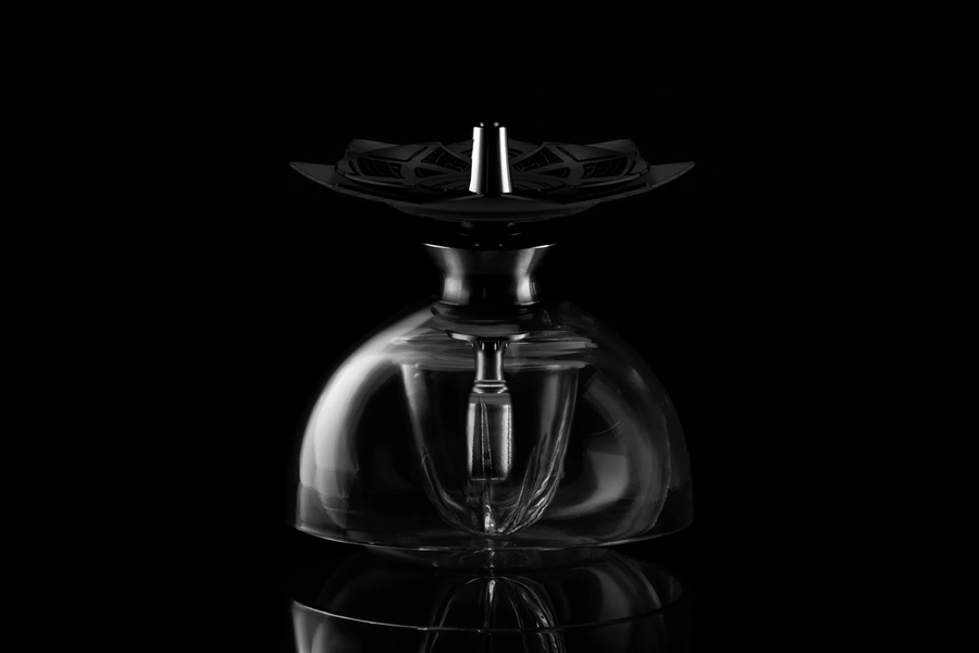 Kaloud Krysalis hookah with a clear glass dome and a Lotus heat management device on top, on black