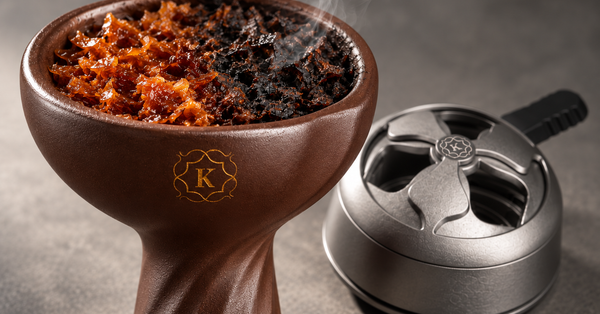 Hookah bowl with fresh, glossy shisha molasses on one side and dark, scorched molasses on the other, beside a Kaloud heat management device