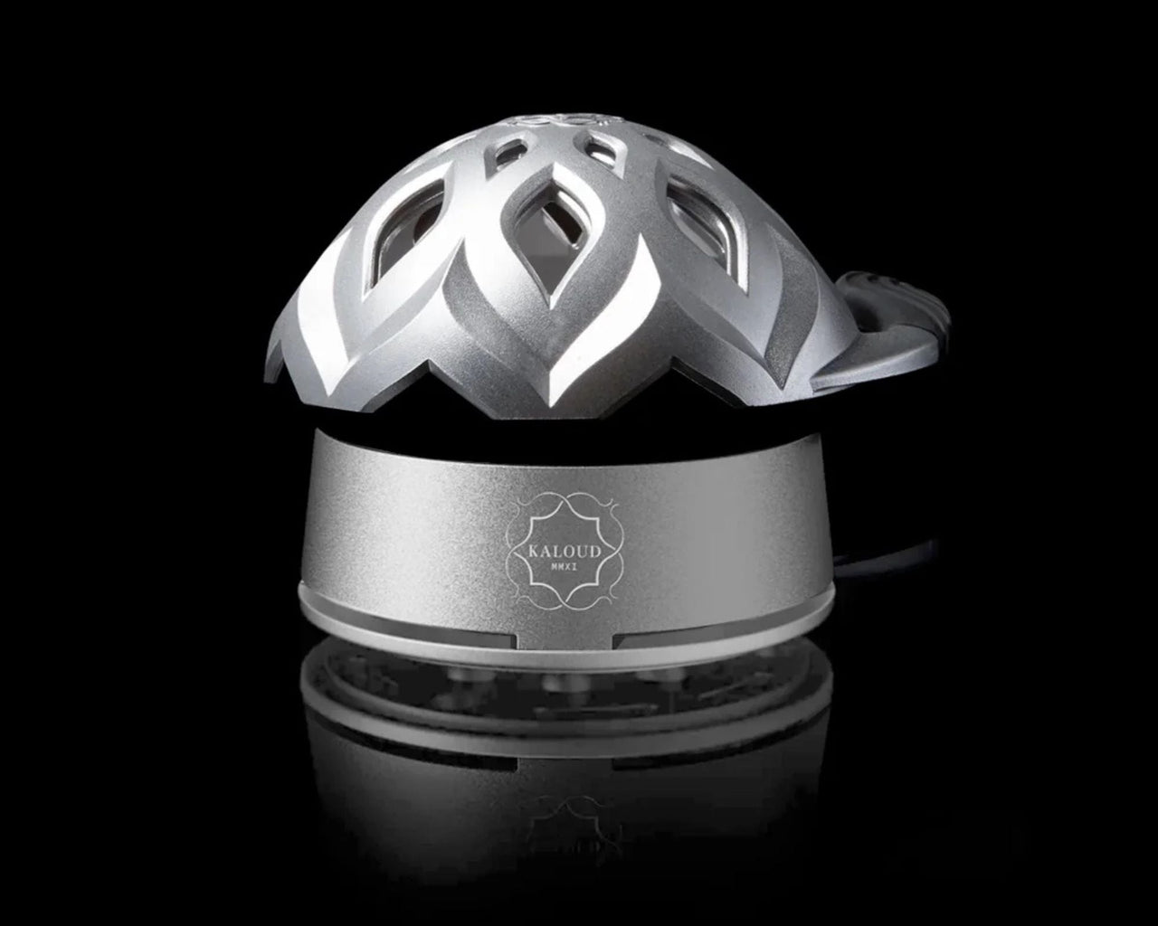 Kaloud Lotus 3 heat management device in brushed aluminum, showing the flame-patterned vent openings on the dome lid