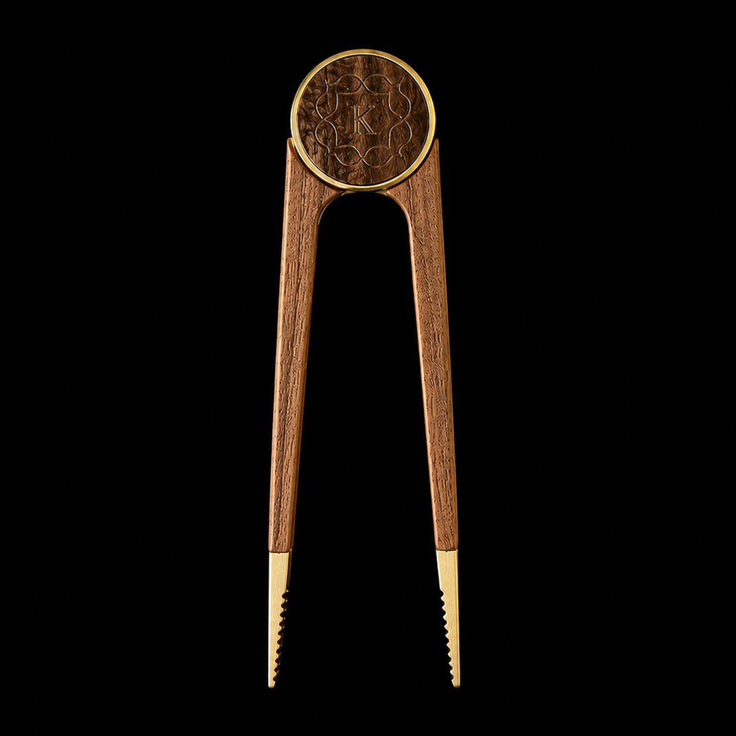 Kaloud Vestara Auris hookah charcoal tongs with wood handles and rose gold tips, precision-grip tongs for safely handling hot hookah coals, front view on black background